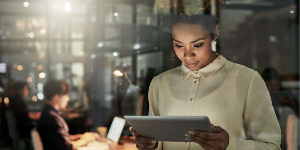 A businesswoman using a tablet in an office