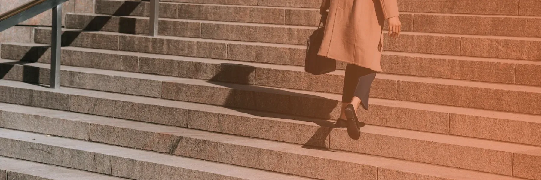 A woman climbing a flight of steps