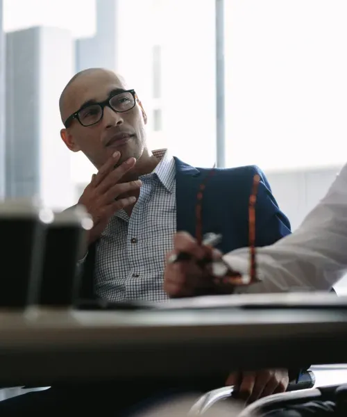 A businessman listening to clients in a meeting