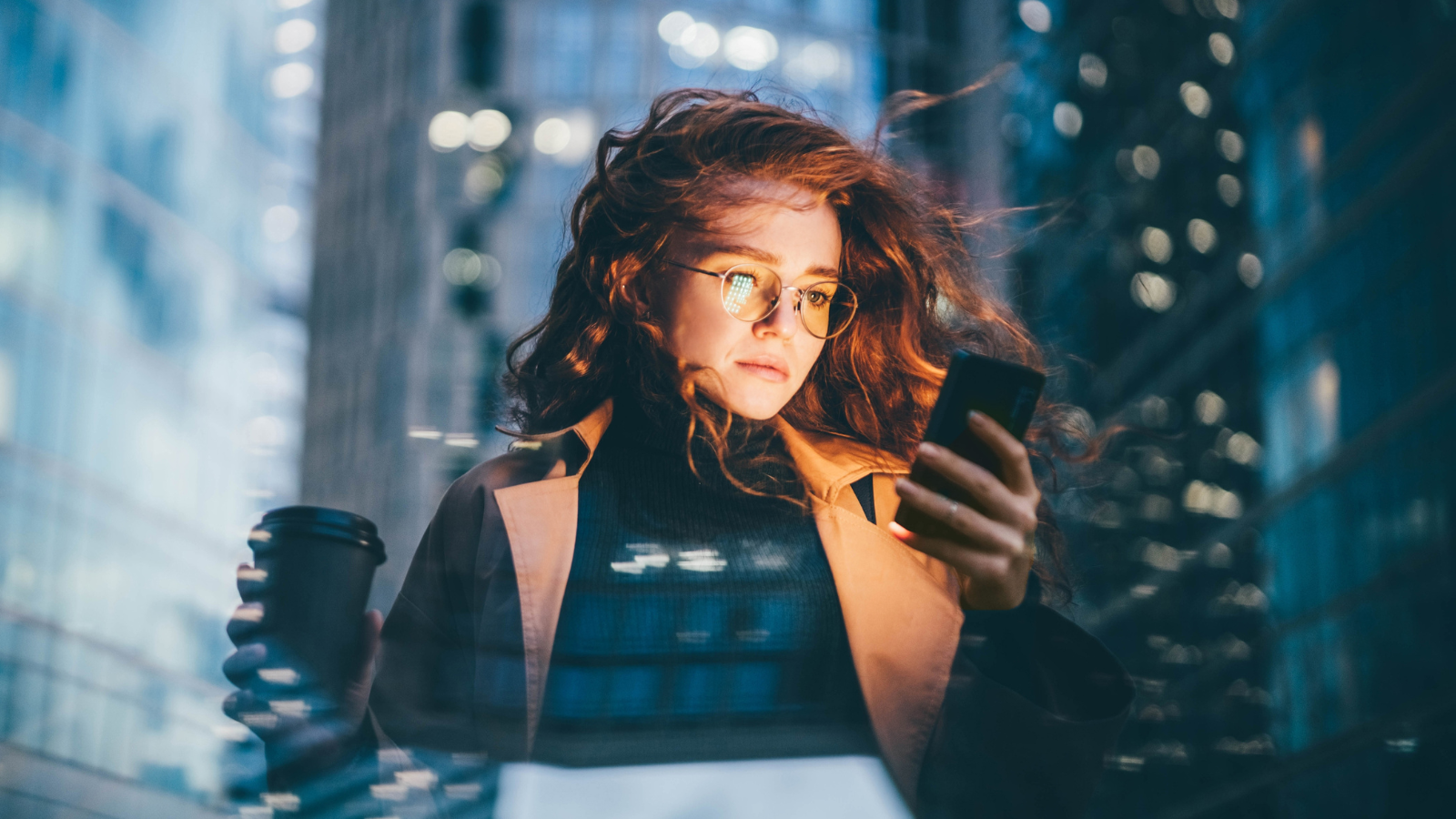 A financial services customer using her mobile phone for online banking